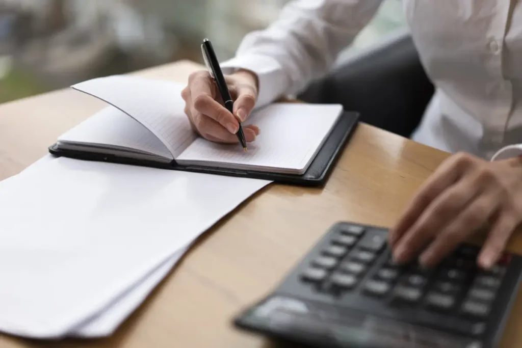 corporate woman calculating writing