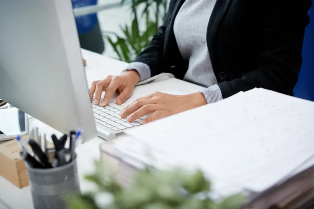 unrecognizable woman sitting desk office typing keyboard unrecognizable woman sitting desk office typing keyboard