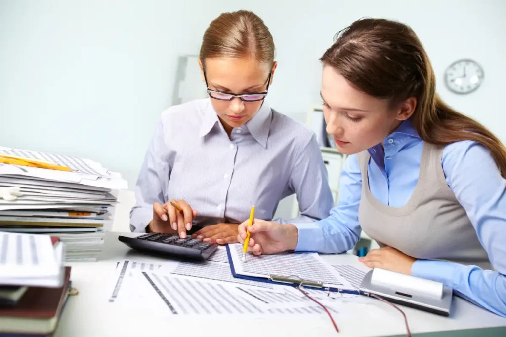 businesswomen reviewing results businesswomen reviewing results